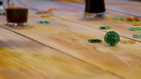 Close-Up-Of-Friends-At-Home-Or-In-Bar-Celebrating-At-St-Patrick's-Day-Party-Drinking-Alcohol-And-Spinning-Novelty-Gold-Coins-1